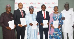L-R: TAJBank Limited Director, Alhaji Tata Shekarau; the bank’s Managing Director/CEO, Mr. Hamid Joda; Board Chairman TAJBank Limited, Alhaji Tanko Gwamna; the bank’s Co-Founder/Executive Director, Mr. Sherif Idi; Director of the bank, Hajia Mariam Ibrahim; and another Director, Mr Jonathan Kagis; displaying the TAJBank’s signed agreement for N20Bn Mudarabah Sukuk Bond Issuance at the bank’s headquarters in Abuja